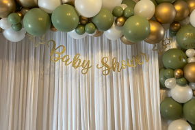 Baby shower balloon garland with satin curtain backdrop