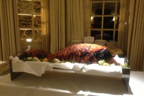 Whole roasted hog displayed on a table as a centre piece