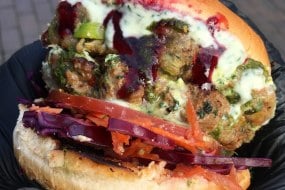 Lamb Kebab burger, aloo tiki, Baba’s spicy green sauce & plum chutney
