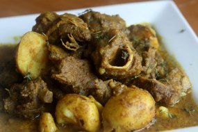 Curried Goat cooked the traditional way. On the bone Medium heat