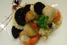 Scallop and black pudding risotto, finished with micro basil and a balsamic glaze