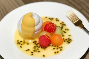 Passionfruit mousse and curd with meringue and a melon salad,
