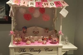 Add a little sweetness to your event with a vintage candy cart