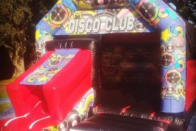 Disco Club Bouncy Castle with slide Hire. https://www.splashinflatables.com/category/bouncy-castles/521/disco-club-bouncy-castle#BodyContent