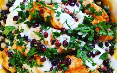 Harissa chicken on roasted chickpeas with a Greek yogurt dressing and pomegranate