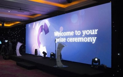 A 10m wide by 3m high 3.9mm pitch LED screen as a stage backdrop for an awards event