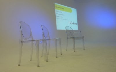 Minimal stage set - ghost chairs and projection in a studio presentation