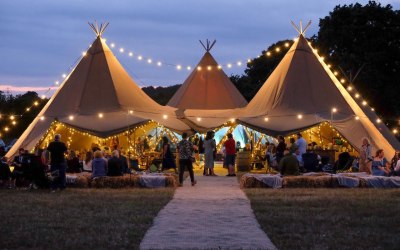 Festival wedding tipis with festoon lighting 