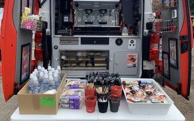 Back of the van with a coffee machine and hot hold for bakes