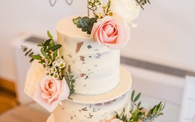 Semi-naked wedding cake with fresh flowers