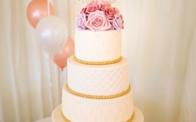 Three tier wedding cake with sugar flowers topper 