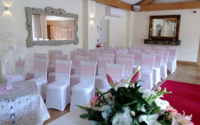Coral wedding sashes and white spandex chair cover hire london