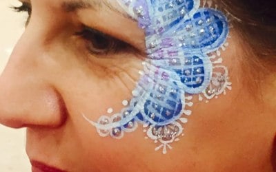 Glittery Blue Lace Eye Design by London Face Painters Happy Canvas