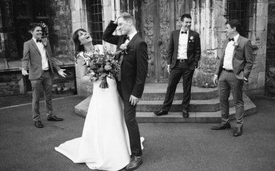 Bride and groom laughing at relaxed wedding at Berkeley castle