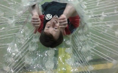 A man playing Zorb bubble football 