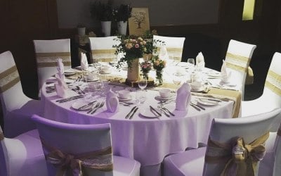 White chair covers and hessian with lace sashes and table runners