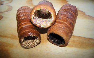 chimney cakes with oreo, nibbed nuts and rainbow toppings