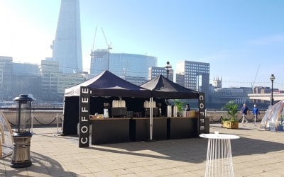 Outdoor setup with two espresso machines by the Thames
