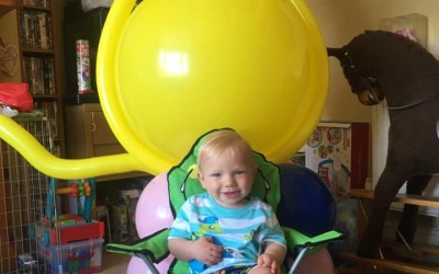 Happy little birthday boy with his giant balloon lion!