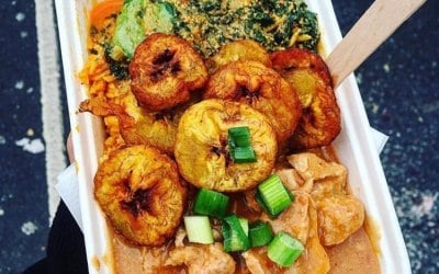 Jollof rice, fried plantains, spinach and agushi and peanut sauce