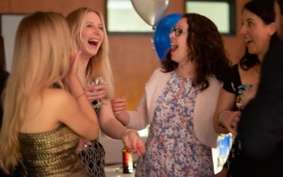 Guests laughing at a close-up corporate event.