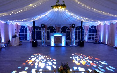 Marquee Wedding at Longthorns Farm, Wareham. 2 large moving heads mounted on podiums and 18 uplighters used to light up the dancefloor area and the dancefloor.