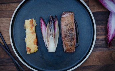 Duck breast with damson sauce, braised chicory and Parmesan polenta slice
