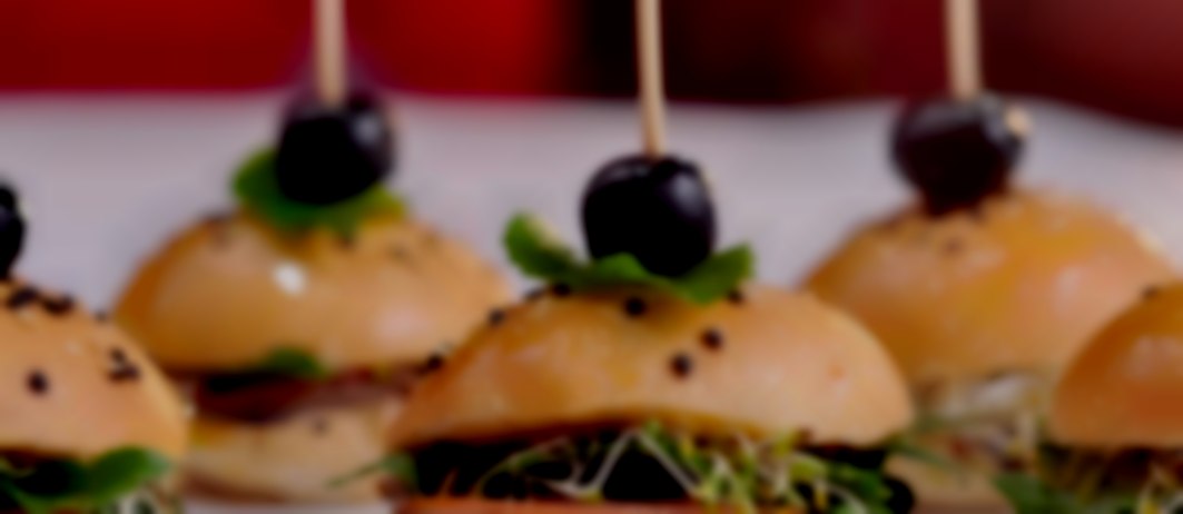 A range of finger food; mini burgers, spring rolls or British sandwiches Finger buffet catering