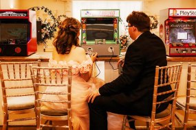 bride-and-groom-playing-retro-video-games-at-wedding.jpg