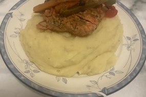 Creamy garlic mash topped with pan fried Cajun salmon with sautéed vegetables 