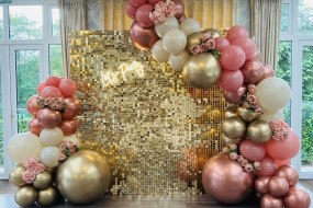 Gold Shimmer wall with a Balloon Garland  and neon sign