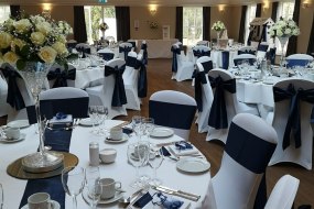 A range of chair covers and sashes for hire, including setup and collection. Centerpieces also available for hire in silk or fresh arrangements.