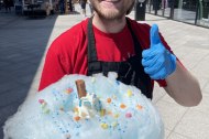 Tom the owner with one of our Cloud 99 Ice creams which is a waffle cone with Jersey dairy ice cream, a soft cloud of candy floss and then topped with a flake sauce and two toppings of your choice.