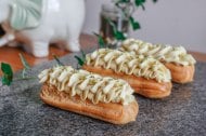 Pistachio mousseline eclairs with white chocolate and pistachio chantilly ripple with crystallised pistachio crumb.