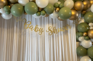Baby shower balloon garland with satin curtain backdrop