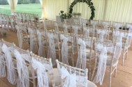 White lace sashes over chiavari chairs