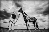 Portrait shoot of an equine physio who illustrates the muscles and bones on the horse