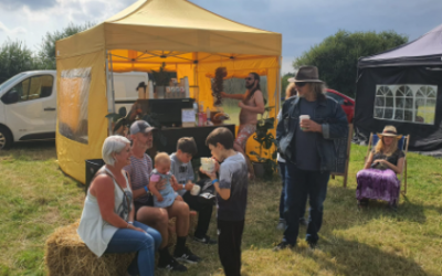 Customers enjoying coffee at a festival.