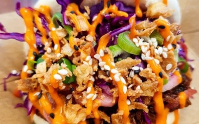 Gochujang Beef with Asian slaw, pickled radishes, spring and crispy onions 