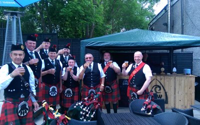 The Pipe Band enjoys their reward.