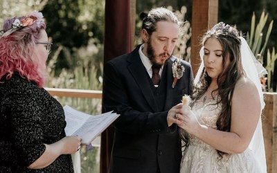 Handfasting couple blowing out the candle on their marriage candle during the fire ritual 