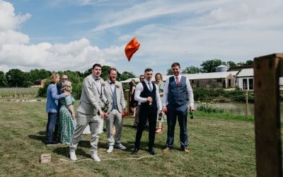 Groomsmen throwing bean bags at our Tin Can Alley Game