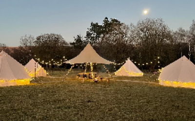 Small bell tent village with centre communal area. 