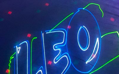 A party logo projected in laser light