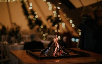 The firepit sparkles inside a Wild Tipi 