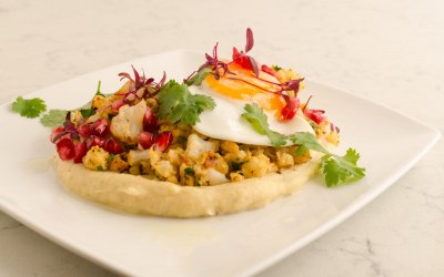 Healthy spiced cauliflower with celeriac pure, pomegranates and fried quails egg