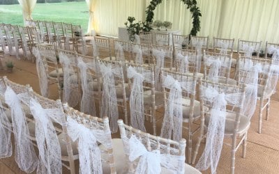 White lace sashes over chiavari chairs