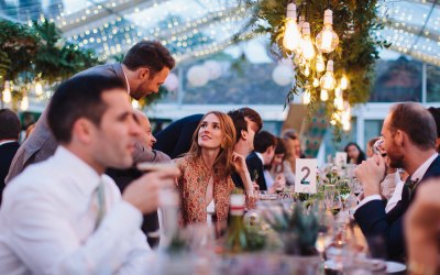 Guest dining under our Edison lighting rig enhanced with green foliage