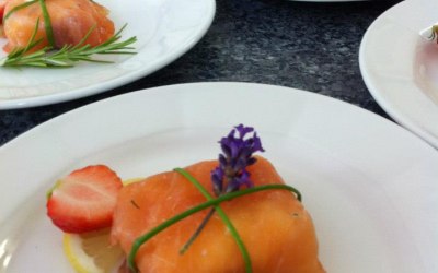 A starter of smoked salmon with goats cheese and beetroot tied with chives.