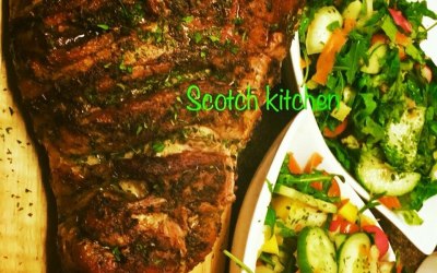 Roasted lamb leg served with salad 